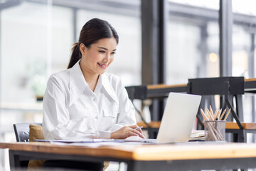 Asian Business woman work in the office. concept of tax, report, accounting, statistics, and analytical research.