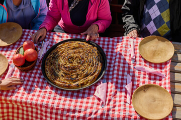 A family on a mountain vacation indulges in the pleasures of a healthy life, savoring traditional pie while surrounded by the breathtaking beauty of nature, fostering family bonds and embracing the