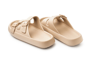 Pair of stylish beige flip-flops on white background