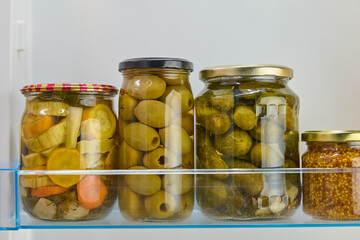 jar of canned olives in the refrigerator