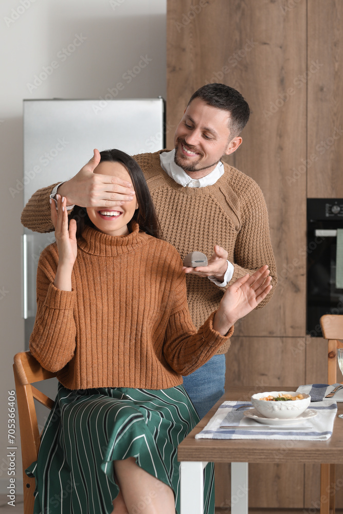 Sticker Young man proposing to his girlfriend in kitchen