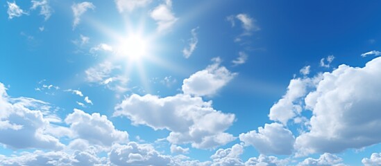 Bright sun on beautiful blue sky with white clouds. - obrazy, fototapety, plakaty