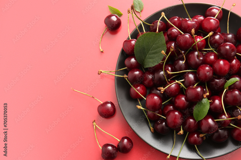 Wall mural plate with sweet cherries on red background - Wall murals