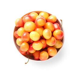 Bowl with sweet yellow cherries on white background