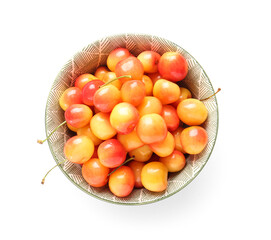 Bowl with sweet yellow cherries on white background