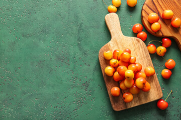 Wooden boards with sweet yellow cherries on green background - Powered by Adobe