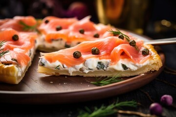 A slice of pizza artistry, this shot highlights an exquisite combination of succulent slices of smoked salmon, tangy capers, slivers of refreshing red onion, and a creamy layer of dillinfused