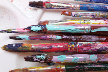 Dirty paint brushes on white background