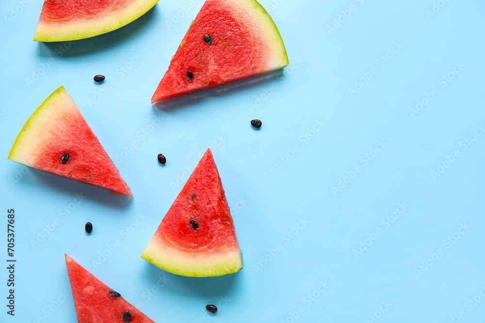Wall mural composition with pieces of ripe watermelon on blue background - Wall murals