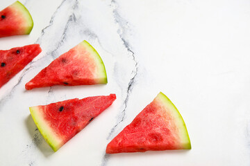 Composition with pieces of fresh ripe watermelon on light background