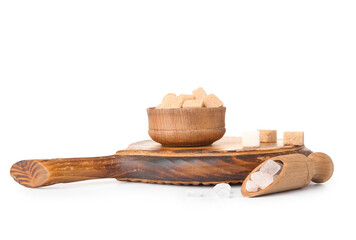 Bowl and scoop with different types of sugar on white background