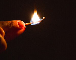 burning match in hand