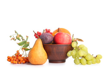 Bowl with different fresh fruits and berries on white background