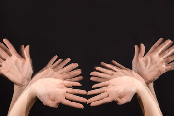 Stroboscopic photo of female hands moving on dark background