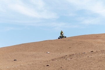 person ridding in the desert