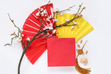 Blank card with Chinese symbols, fortune cookie and branch of flowers on white background. New Year...
