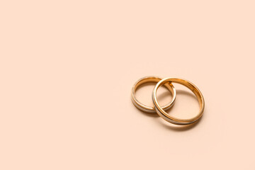 Beautiful wedding rings on beige background