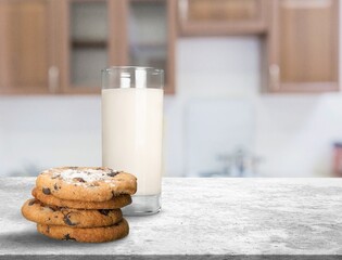 Plate with tasty sweet cookies and milk on table