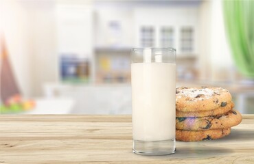 Plate with tasty sweet cookies and milk on table