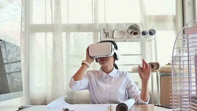 Architect young woman working with virtual reality technology modeling software applications in the office. Use augmented reality modeling in Building Information Model (BIM) tech system complete.