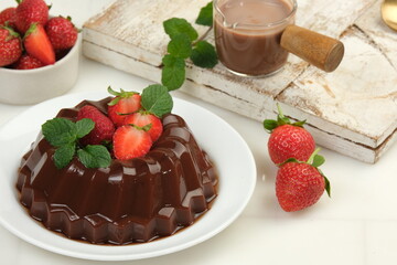 Chocolate pudding or puding coklat with strawberry,delicious sweet dessert on white background