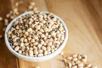 black-eyed pea in white ceramic bowl on wooden table background