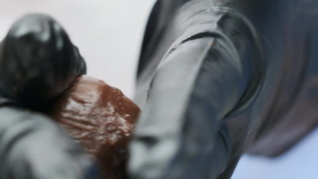 Chef shapes chocolate orb with precision and finesse closeup. Confectioner highlights tactile nuances of sweet crafting during private master class