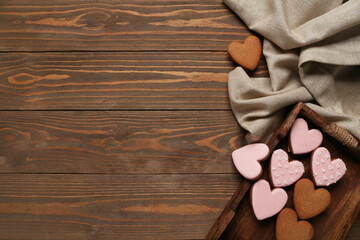 Tray with tasty heart shaped cookies and tablecloth on wooden background. Valentine's Day celebration - obrazy, fototapety, plakaty