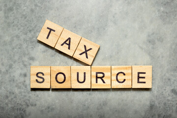 Wooden cubes with TAX SOURCE letters