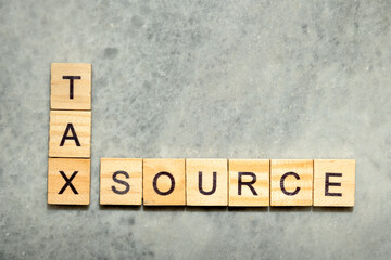 Wooden cubes with TAX SOURCE letters