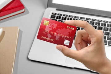 People hand holding credit cards with laptops for payment, banking, or online shopping