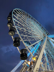 looking up at a Ferris wheel at night
