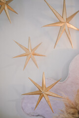 Fototapeta na wymiar Ornalental golden stars hanging decoratin in a cafe or restaurant for special holiday ramadan or valentine day