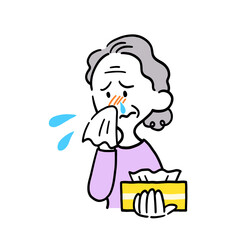 ティッシュで鼻をかむ高齢女性