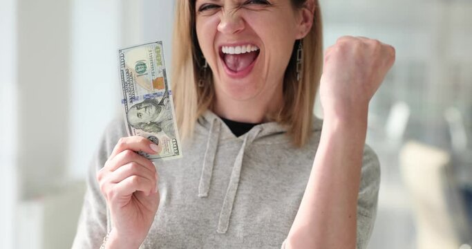 Happy cheerful happy woman receiving first 100 dollars