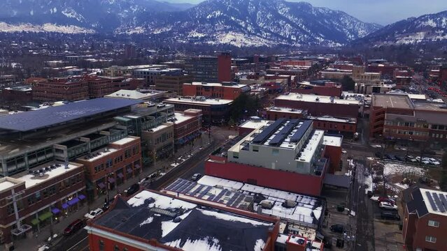 Christmas in Boulder Colorado Pearl Street Mall cars buildings streets Baseline aerial drone cinematic December University of Colorado CU Buffs Winter cloudy snowy Flat Irons Chautauqua Park up reveal