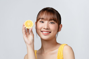 Energy. Close up of beautiful young woman with lemon slices on white background.