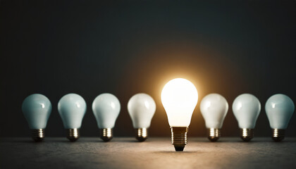 Bright lightbulb amidst dark, symbolizing innovation & creativity in a barren space, with room for imagination