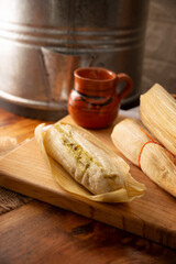 Tamales. hispanic dish typical of Mexico and some Latin American countries. Corn dough wrapped in corn leaves. The tamales are steamed.