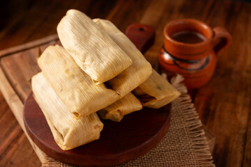Fototapeta na wymiar Tamales. hispanic dish typical of Mexico and some Latin American countries. Corn dough wrapped in corn leaves. The tamales are steamed.