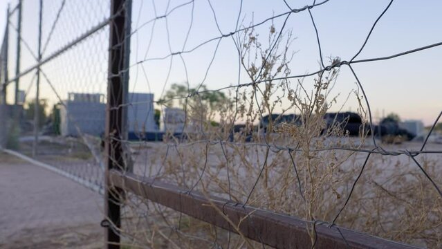 Wire fence with dry dead weeds in Australian outback town