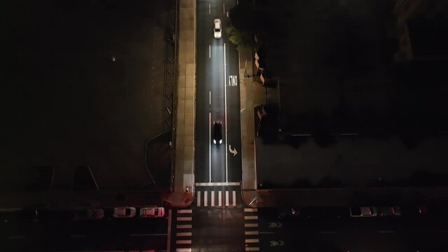 Fort Worth, Texas traffic intersection at night with drone video tilting up.