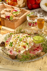 Stroganina of fish on ice garnished with pine branches, a classic Russian cuisine starter
