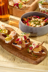 Open-faced sandwiches with pork belly and pâté, mini appetizers on a Russian-style table
