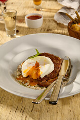 Beefsteak with an egg and white mushrooms, a rich and savory dish