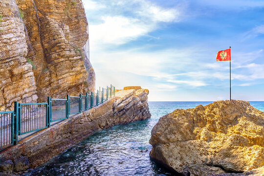 Flag of Montenegro on one of the beautiful rocky coasts of Montenegro