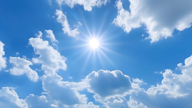 Sun with rays and glare clear blue sky and clouds Sunshine in a blue sky with white cumulus clouds in bright weather