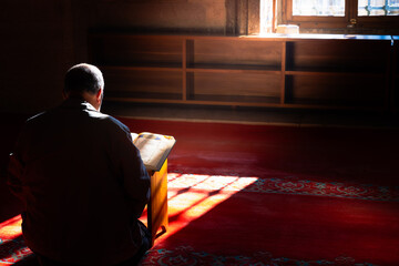 Islamic concept photo. A muslim man reading the Holy Quran