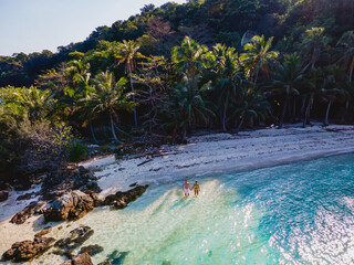 Koh Wai Island Thailand tropical Island near Koh Chang, couple of men and woman on the beach