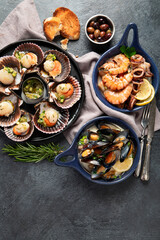 Fried scallops with butter and green sauce served in seashells.